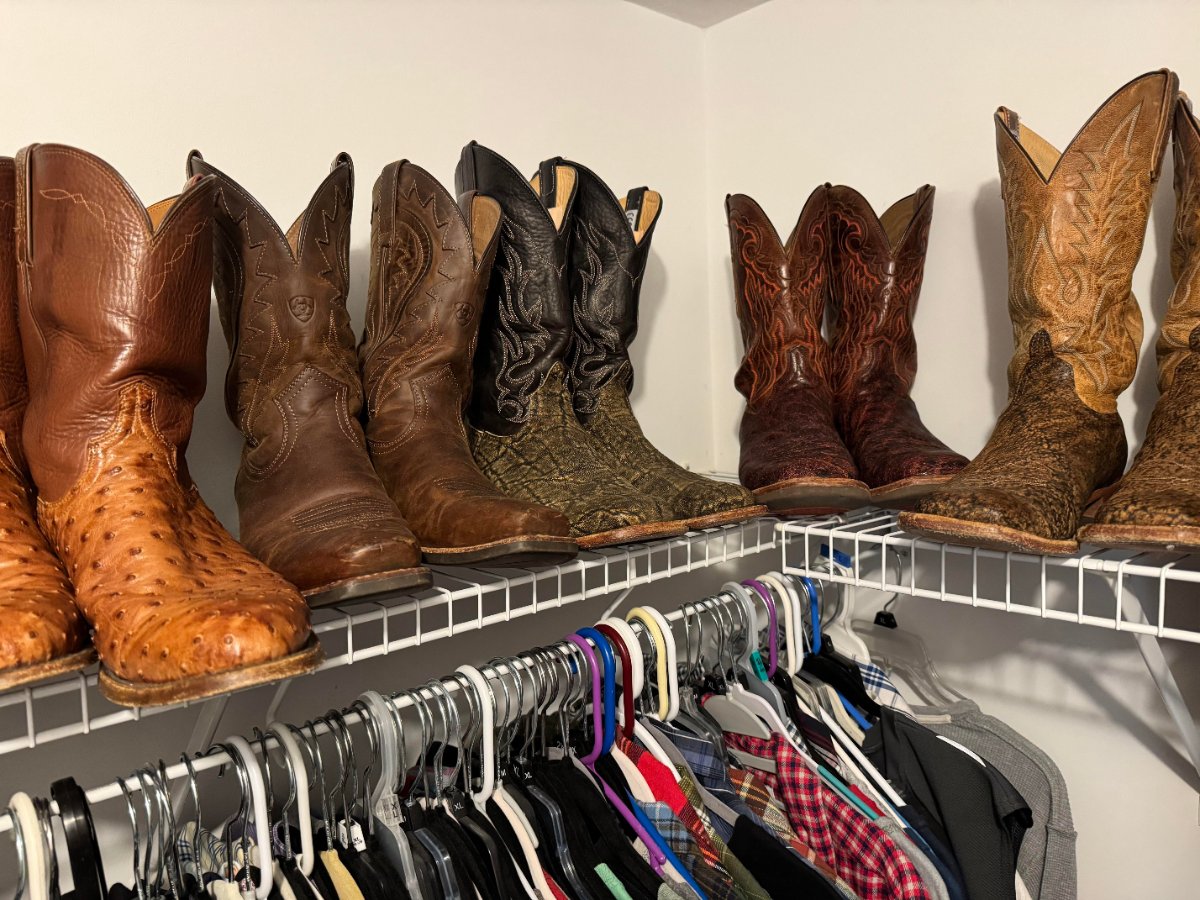 Thomas Scheetz's cowboy boots lined up on a closet shelf, including ostrich, elephant and other exotic leathers